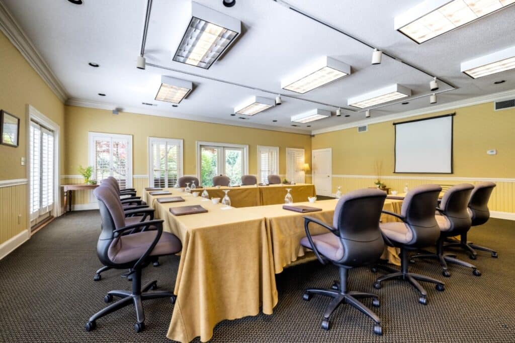 A meeting room inside with sunlight coming through the windows