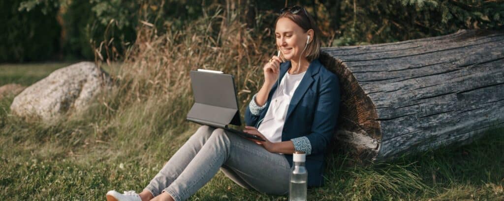 Woman working remotely on a laptop outdoors