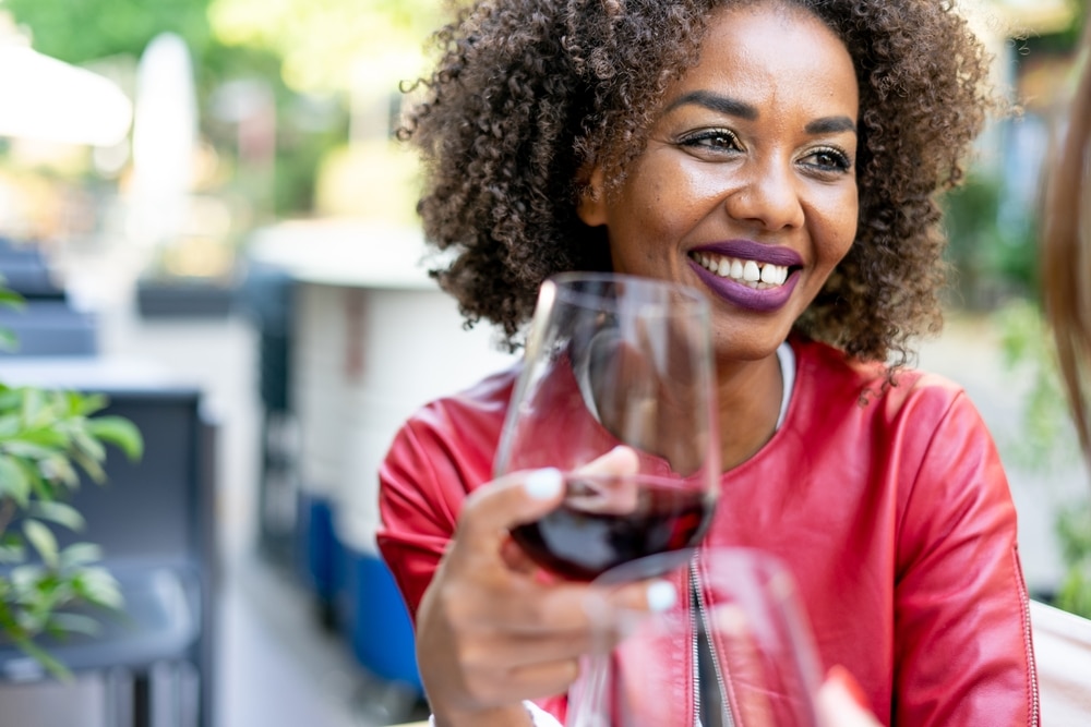 Woman enjoying glass of red wine at best North Georgia wineries