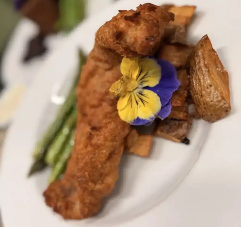 A Wellness Retreat in the North Georgia Mountains That Changes Everything 2 Chef-crafted entree with asparagus, roasted potatoes and an edible flower garnish at Glen-Ella Springs