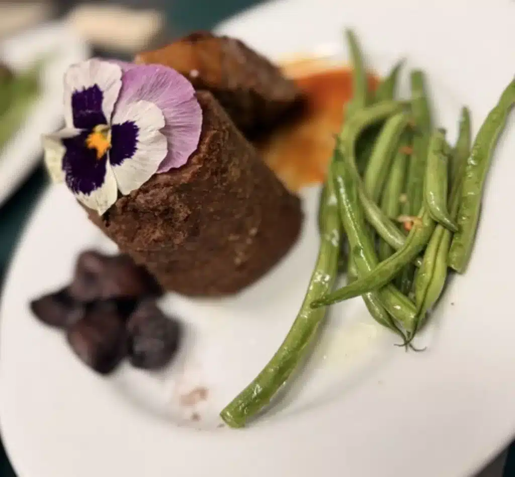 A Wellness Retreat in the North Georgia Mountains That Changes Everything 3 Plated filet with green beans, sweet potato and an edible pansy garnish at Glen-Ella Springs